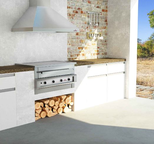 Hybrid Braai, 4 burner unit set into a white outdoor kitchen run with a log store beneath it