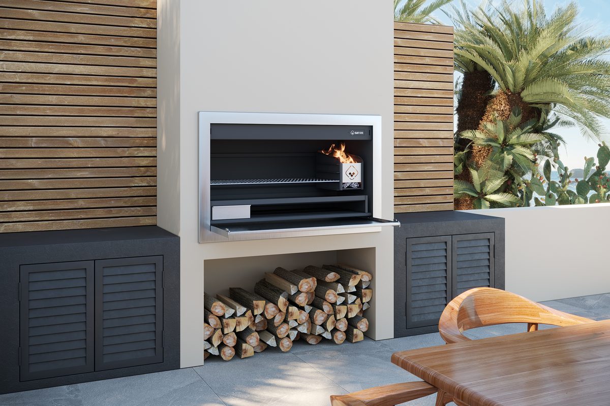 SAFire Affordable Luxury braai built into a wall with a fire alight, the door dropped open and logs stacked below