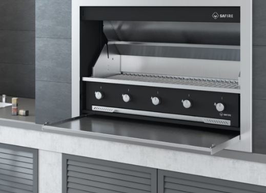 SAFire five burner gas braai built into a stone counter, with its slide-in door folded down